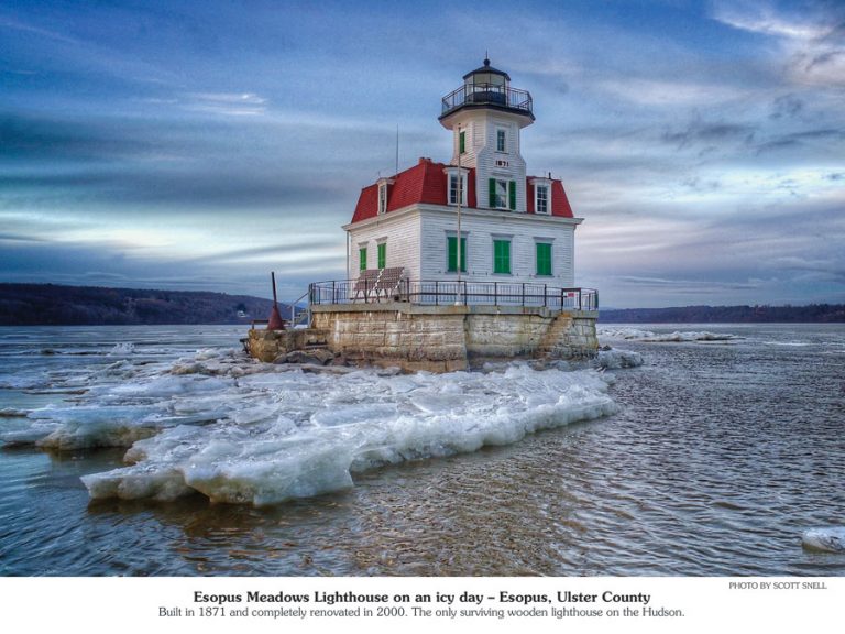 Lighthouse with a red rood in icy waters.