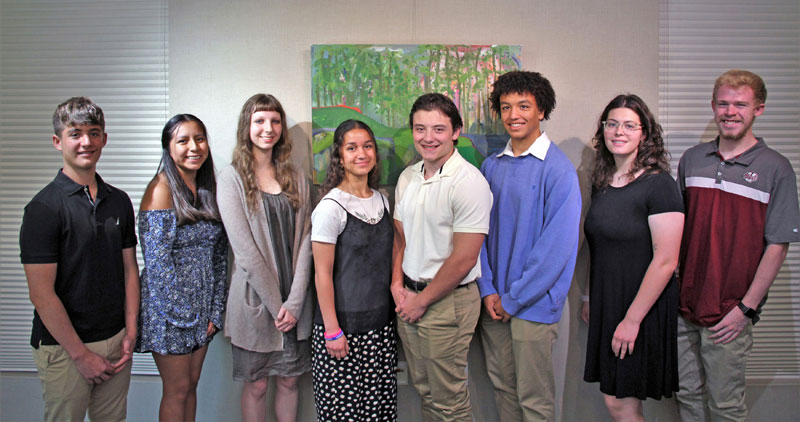 Eight students that were awarded scholarships pose for a group photo.